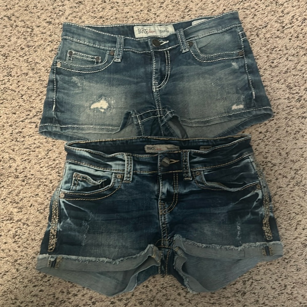 2 pair BKE denim shorts. Previously worn. Size 25. Mild distressed.orig buttons